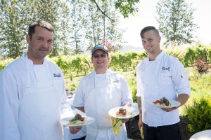 Chefs holding plates of food